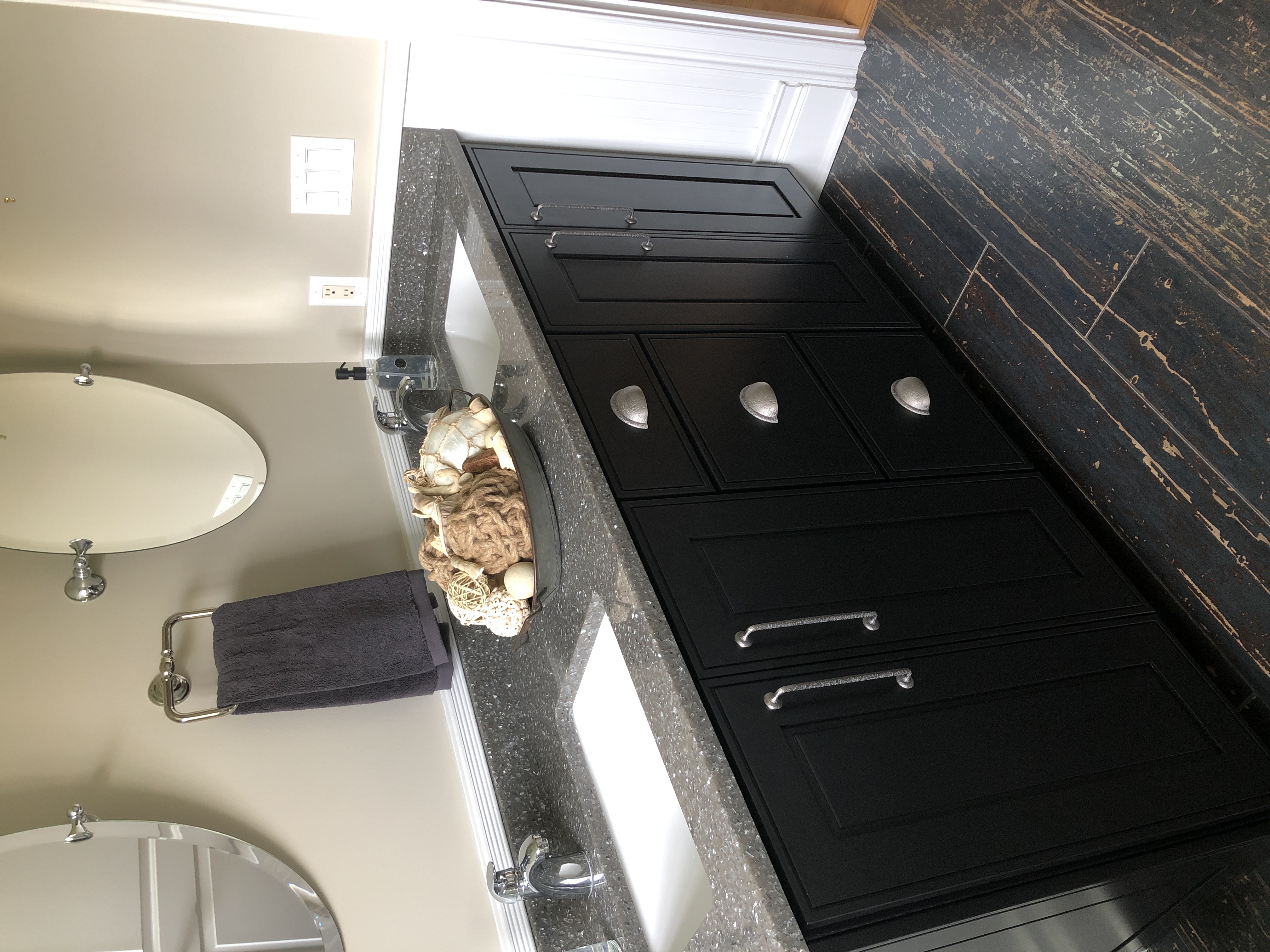 A double sink vanity with a distressed wood floor