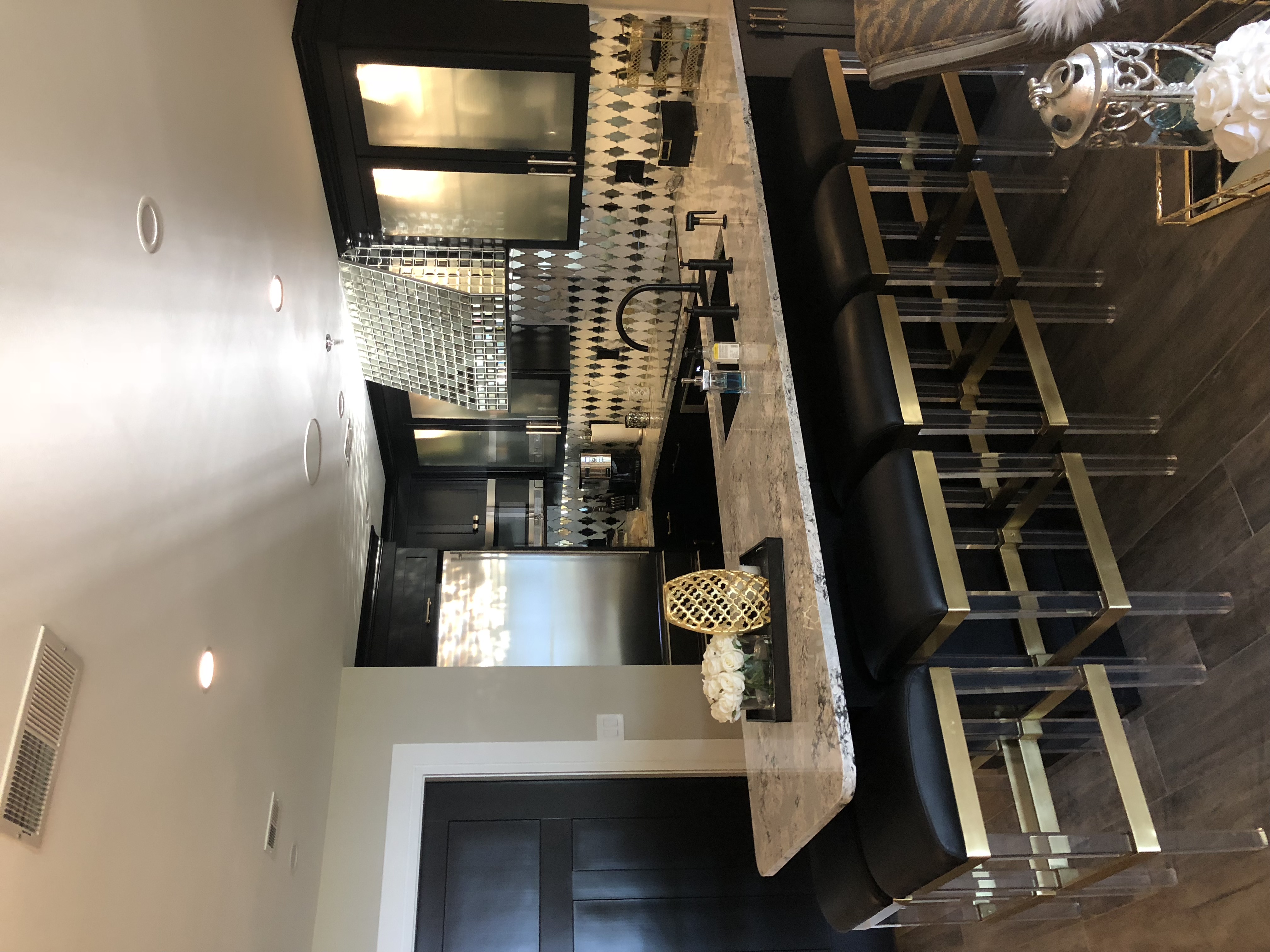 The long kitchen counter with stools underneath